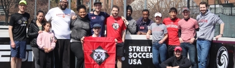 Alumni Group pose holding Davidson flag