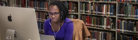 Student Working on Lab Computer and Laptop