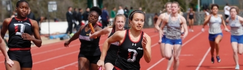 Track Team Runners in Relay