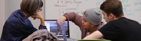 Prof. Churchill and Students Looking at Laptop