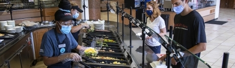 Masked Vail Commons Staff Serve Salads to Masked Students