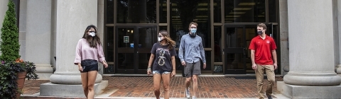 Cats Wear Masks - Students wearing masks in front of the library