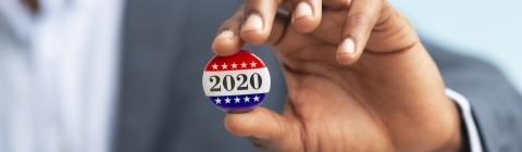 Vote 2020 Man holding a 2020 pin