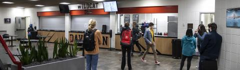 Socially distanced and masked Students stand in line for Wildcat Den