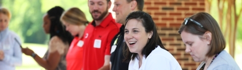 College Relations Staff Smiling and Checking People In
