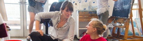 Art Professor Katie St. Clair speaks with student in studio class