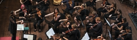 Davidson College Symphone Orchestra bird's eye view of group performing on stage