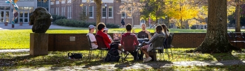 Prof. Patricio Boyer and Students gather outside on a beautiful fall day