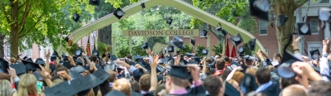 Davidson College Commencement Carol in the background as students throw up their caps