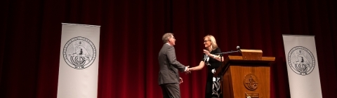 Doug Hicks and Alison Mauzé on stage with Davidson signs