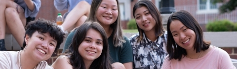 students smiling sitting on steps