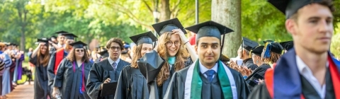 procession of students in caps and gowns