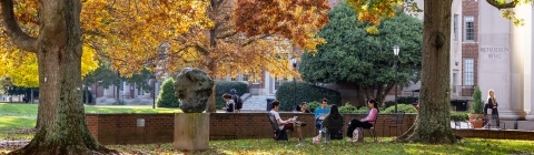 campus scene in front of colorful trees