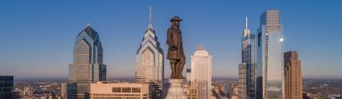 Philadelphia skyscrapers with Penn statue in foreground and blue skies in background