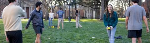 Students playing spikeball on campus