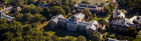 Aerial view of campus with one large building in the center