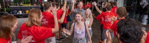 Students and families entering welcome tunnel during orientation