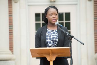 Jocelyn Kennedy '17 stands at podium in front of Chambers for the Law School Induction Ceremony