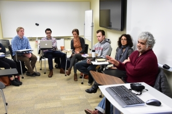 Arab studies class arranges desk in a circle while listening to a discussion led by Khaled Khalifa, a Syrian screenwriter and novelist