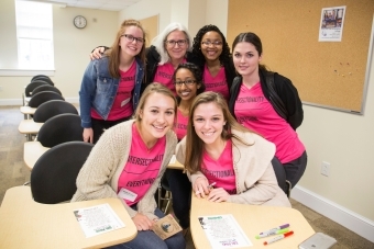 Women's Leadership Conference speakers gather in a classroom