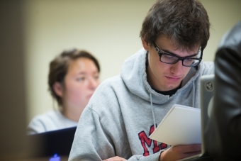 Student analyzes paper in class