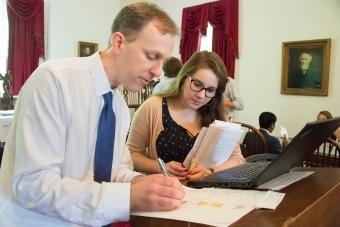 Graham Bullock and student analyze a chart