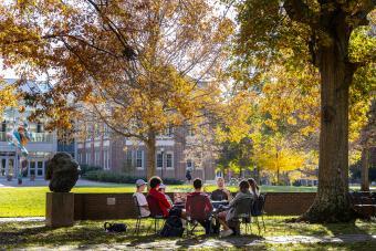 Prof. Patricio Boyer and Students gather outside on a beautiful fall day