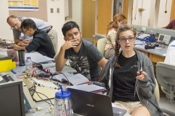 students discussing in physics lab