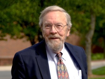 Hansford M. Epes stands and smiles at the camera while wearing a suit