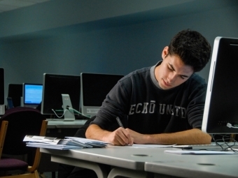 Student works at computer in a computer lab