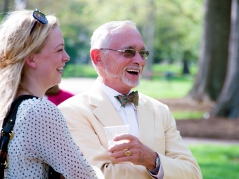 James Pepper '65 smiles next to another person while standing outside