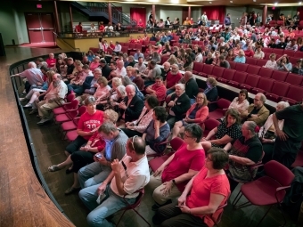 Birds eye view of duke performance hall with all staff sitting in the seats