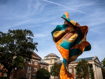 Wind sculpture in the foreground with Chambers in the background