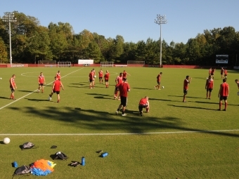 Alumni Soccer Stadium field during a soccer team practice where team members are scattered across the field