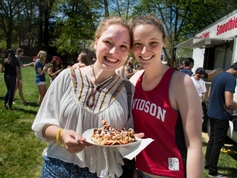 Patterson court during Frolics, students pose together after grabbing a funnel cake