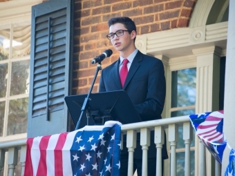 Student stands at Eu Hall for political debate