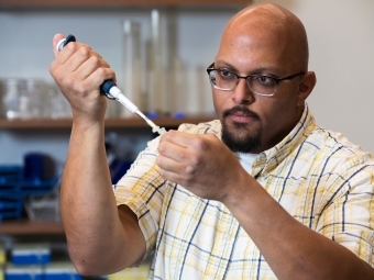 Prof. Mark Barsoum in lab pipetting into test tube