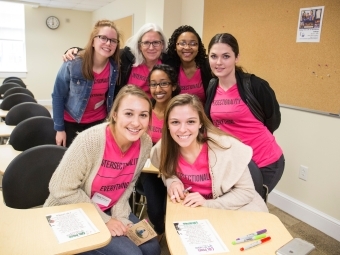 Women's Leadership Conference speakers gather in a classroom