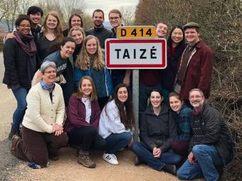 Pilgrimage to Taizé where students pose by Taizé sign