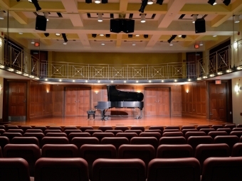 Tyler-Tallman auditorium with piano on stage and open seating