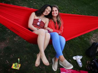 Two students on a red hammock