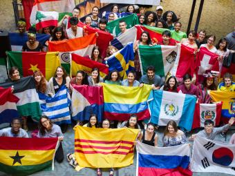 Students hold flags from many different countries