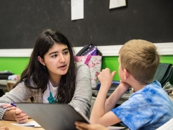 Student tutors elementary student