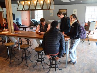 Students gather at Summit Outpost and chat at a table