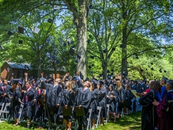 Graduates of the Class of 2019 throw their caps in the air