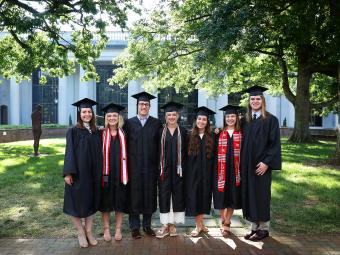Belk Scholars Class of 2019 pose for a photo in graduation regalia