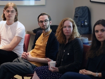 Students listen to other students speaking at seminar