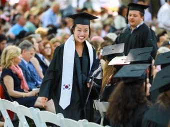 Student Smiles with diploma