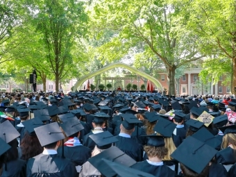 Class Caps lined up with stage in the background