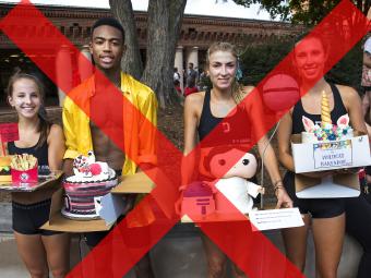 Students holds cakes after the race but the image is covered by a red x